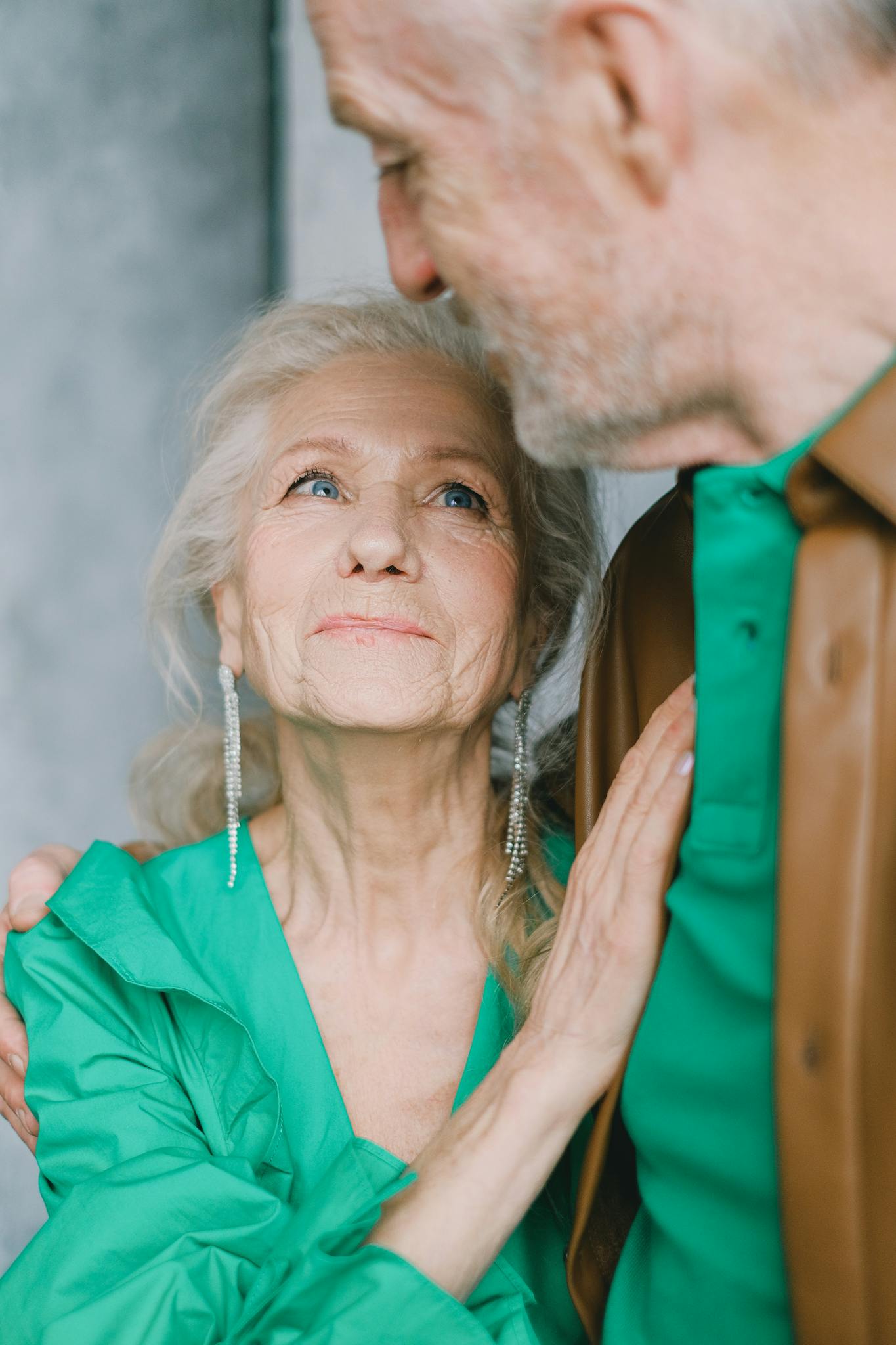 Elderly couple sharing a tender moment of love and togetherness indoors.