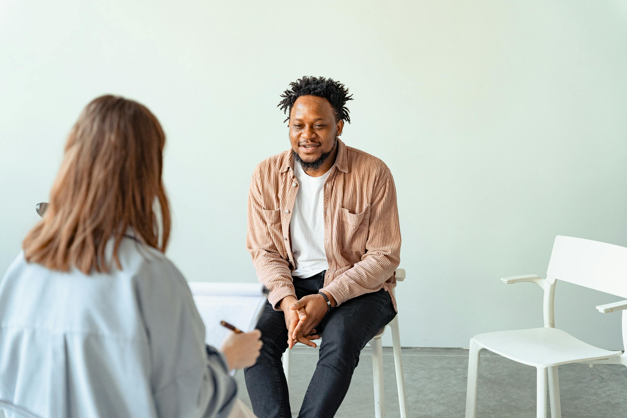 Client and therapist seated in an in-person therapy office