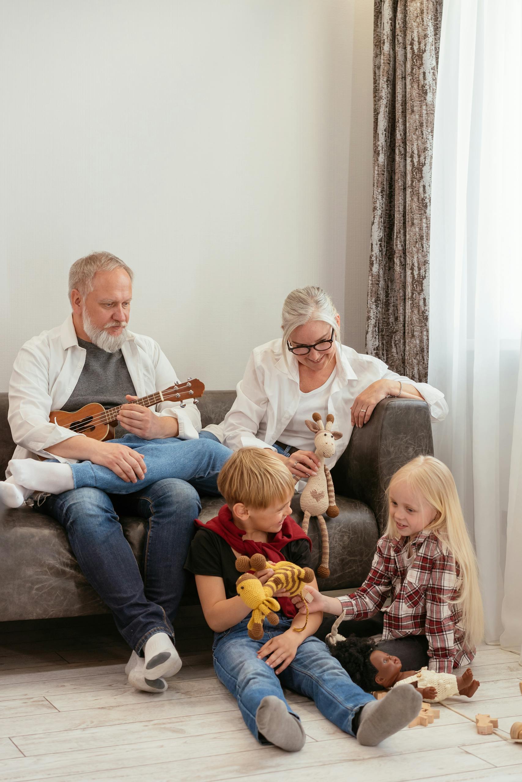 Grandparents and kids enjoying quality time indoors with ukulele and toys.